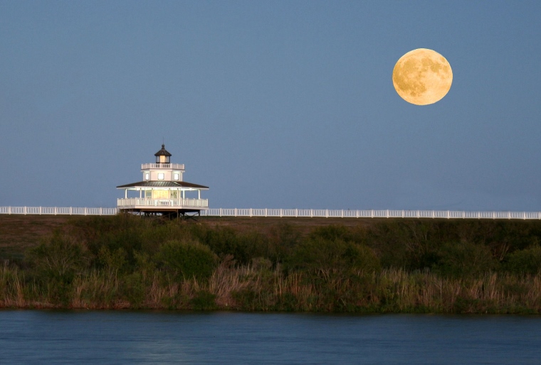 decorative image of a lighthouse under the moon